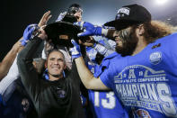 Memphis head coach Mike Norvell, left, celebrates with he team after they defeated Cincinnati in an NCAA college football game for the American Athletic Conference championship Saturday, Dec. 7, 2019, in Memphis, Tenn. (AP Photo/Mark Humphrey)