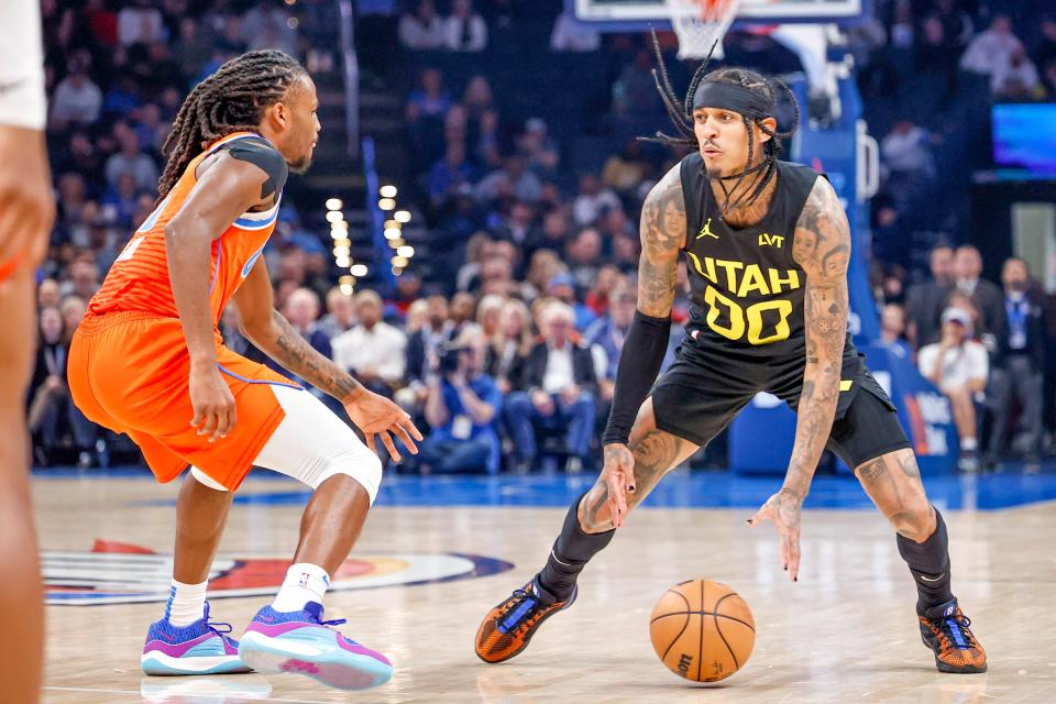 Utah guard Jordan Clarkson (00) looks to pass past Oklahoma City guard Cason Wallace (22) in the second quarter during an NBA game between the Oklahoma City Thunder and the Utah Jazz at the Paycom Center in Oklahoma City, on Monday, Dec. 11, 2023.