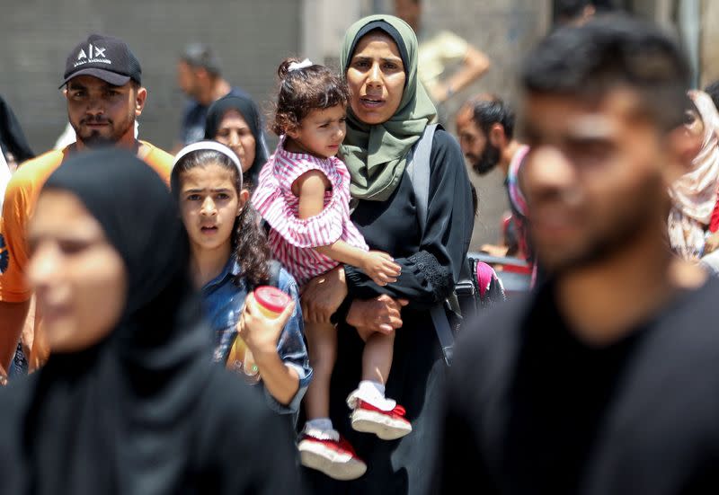 Palestinians flee their homes following an Israeli military operation in Shejaiya, amid Israel-Hamas conflict, in Gaza City