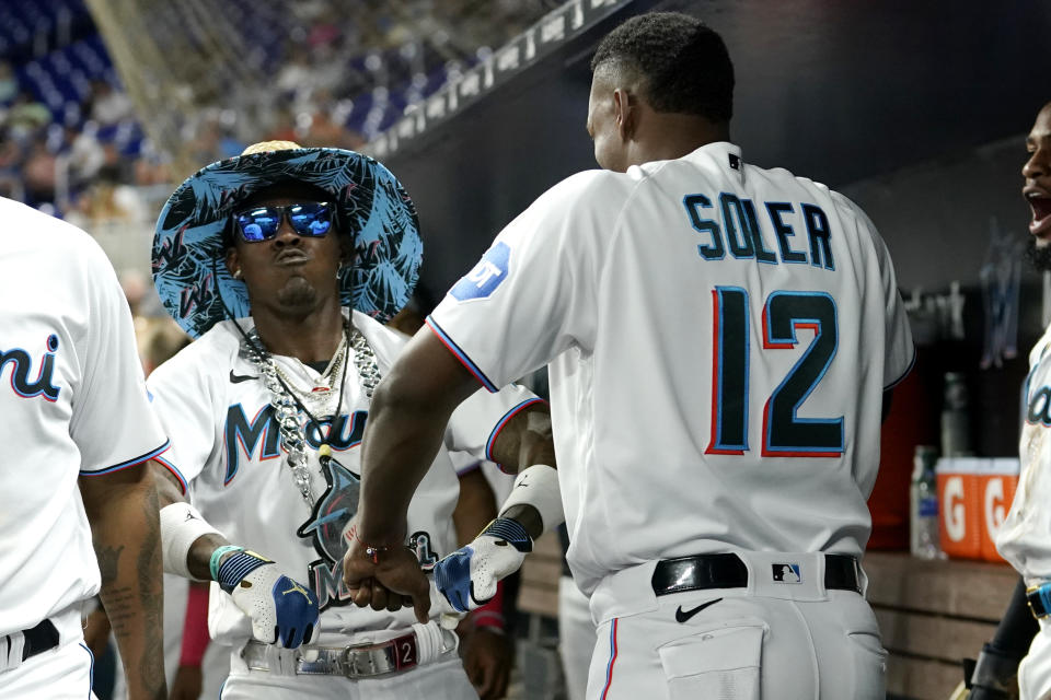 Miami Marlins' Jazz Chisholm Jr., left, celebrates with Jorge Soler (12) after hitting a three-run home run during the fourth inning of a baseball game against the San Francisco Giants, Tuesday, April 18, 2023, in Miami. (AP Photo/Lynne Sladky)