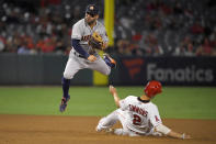 Los Angeles Angels' Andrelton Simmons, right, is forced out at second as Houston Astros second baseman Jose Altuve attempts to throw out Kevan Smith at first during the ninth inning of a baseball game Saturday, Sept. 28, 2019, in Anaheim, Calif. Smith was safe at first on the play. (AP Photo/Mark J. Terrill)