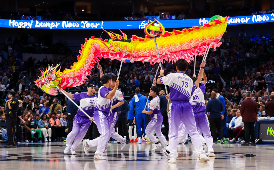 Feb 10, 2024; Dallas, Texas, USA; Dallas Mavericks celebrate the Lunar New Year with performers during the game against the Oklahoma City Thunder at American Airlines Center. Mandatory Credit: Kevin Jairaj-USA TODAY Sports