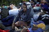 Migrants, mainly from Central America and marching in a caravan, rest on a road near Ignacio Zaragoza, Chiapas