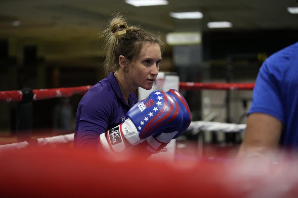 FILE - USA Boxing team member Ginny Fuchs takes part in drills during media day for the team in a gym located in a converted Macy's Department store in Colorado Springs, Colo., in this Monday, June 7, 2021, file photo. Ginny Fuchs’ obsessive-compulsive disorder sometimes compels her to use a dozen toothbrushes a night and to buy hundreds of dollars of cleaning products per week. Yet Fuchs is headed to Tokyo next week to compete in the Olympic boxing tournament, where she realizes it’s almost impossible to avoid touching the blood, sweat and spit of her opponents.(AP Photo/David Zalubowski, File)