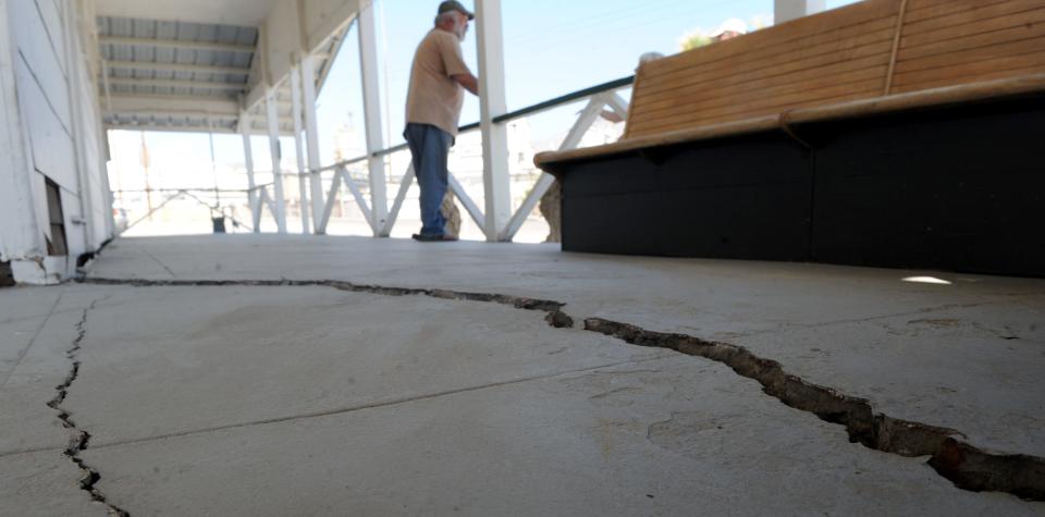 The day after a magnitude 7.1 earthquake, Mike Ashford looks over the damage at the Old Guest House Museum in Trona.  The museum sustained substantial cracks to its foundation.