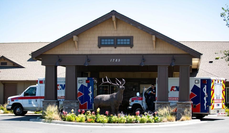 Two American Medical Response ambulances arrive at Canyon Creek Memory Care Community in Billings, Mont. on Thursday, July 9, 2020. There have been multiple deaths related to a COVID-19 outbreak at the center, which declined the state's offer for no-cost testing for the respiratory virus. (Mike Clark/The Billings Gazette via AP)