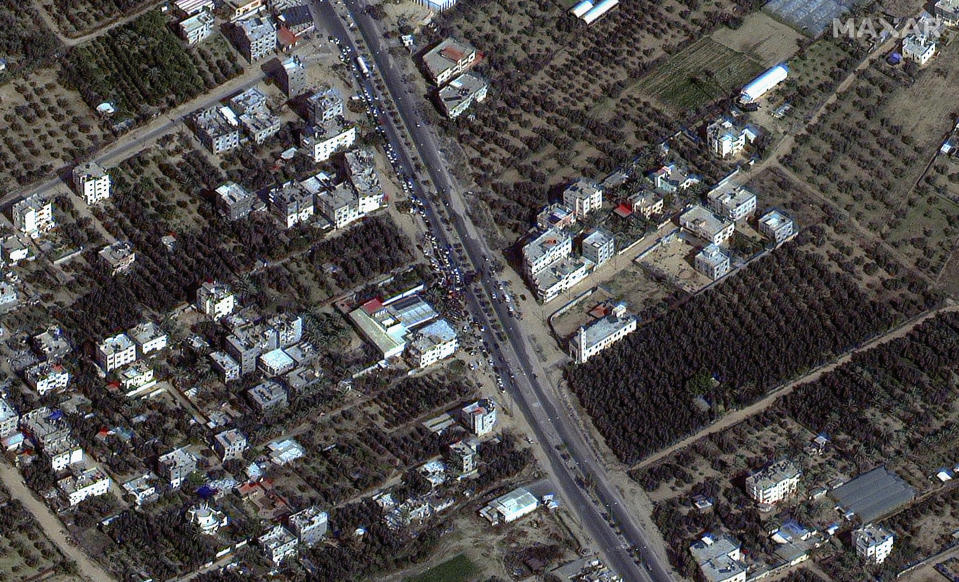 This satellite image provided by Maxar Technologies shows a crowd waiting for gas on Salah al-Din Road, in Gaza, on Sunday, Nov. 26, 2023. The cease-fire between Israel and Hamas began Friday, Nov. 24. (Satellite image ©2023 Maxar Technologies via AP)