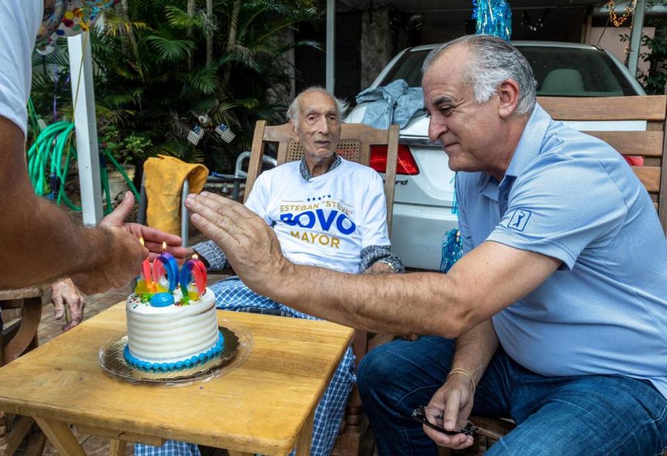 Hialeah mayoral candidate Esteban ‘Steve’ Bovo shields the candles on a cake for Reynaldo Flores, who recently turned 100 years old. Mr. Bovo stopped by Mr. Flores’ house on Sept. 23, 2021, while he was out knocking on doors in the neighborhood.