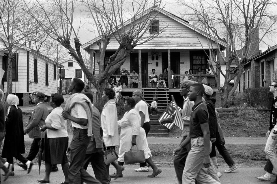 Marchers on the way to Montgomery as families watch from their porches, 1965.