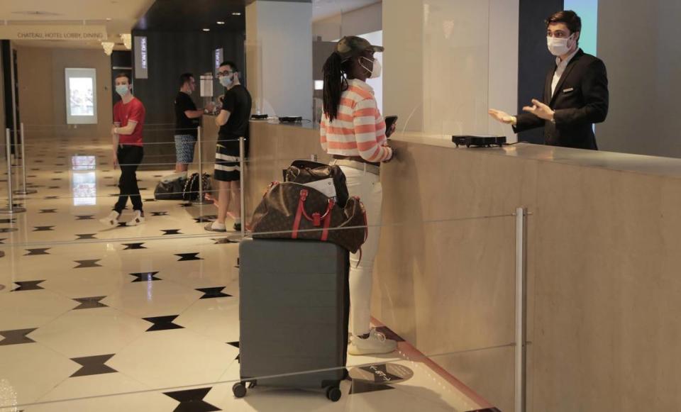 Miami Beach, Florida, June 1, 2020- Latoya Ruckner, from Detroit, Michigan, wearing the striped shirt, at the front desk checks in at the Fontainebleau Miami Beach.