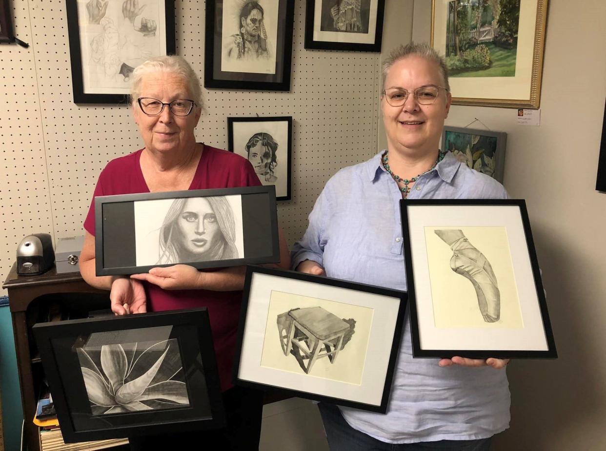 From left to right, Ann Allen of Colonial Heights and Cindy Hamlin of Chester pose with graphite pencil artwork they created during drawing classes at Side Street Gallery in Colonial Heights.