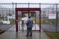 Attorney Matt Boles, 27, with the Southern Poverty Law Center's Southeast Immigrant Freedom Initiative, heads to immigration court at the Stewart Detention Center, Friday Nov. 15, 2019, in Lumpkin, Ga. Visitors to the immigration court pass through two sliding gates set into chain link fencing topped by loops of razor wire, the first gate closing behind them before the second opens. "When you go to court, it's not very welcoming because of the security measures. It's in so many ways a reminder of why I want to win so badly," says Boles. "I think that walking into that environment reinforces the desire to give hope to people and get them free to be with their families." (AP Photo/David Goldman)
