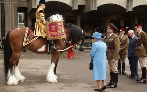 Queen Elizabeth II and Prince Charles, Prince of Wales meet Lance Corporal Richard Brown on Drum Horse Perseus - Credit: Getty Images Europe