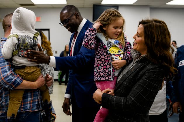 Whitmer holds 3-year-old Emmeline Miller, at the conclusion of a campaign event at the UAW Local 3000 offices in Woodhaven, Michigan, on Oct. 26. (Photo: Brittany Greeson for HuffPost)