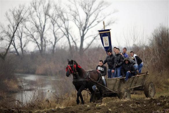 Villagers travel on a horse cart to attend the Orthodox Epiphany Day celebrations in Serdanu village, northwest of Bucharest, January 6, 2012. REUTERS/Radu Sigheti