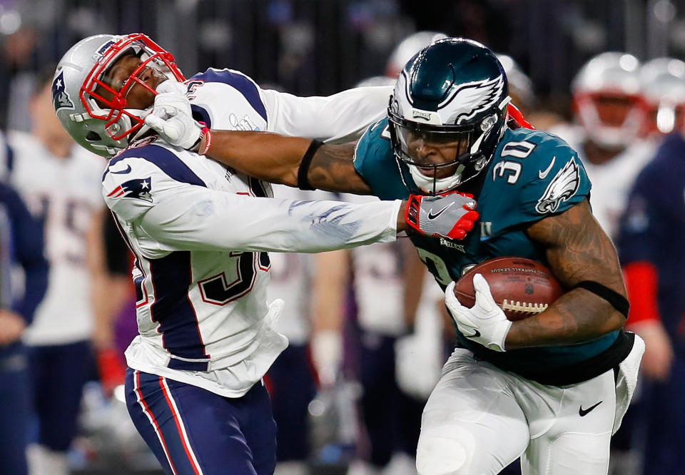 <p>Corey Clement #30 of the Philadelphia Eagles runs the ball past Duron Harmon #30 of the New England Patriots for a 55-yard gain during the second quarter in Super Bowl LII at U.S. Bank Stadium on February 4, 2018 in Minneapolis, Minnesota. (Photo by Kevin C. Cox/Getty Images) </p>