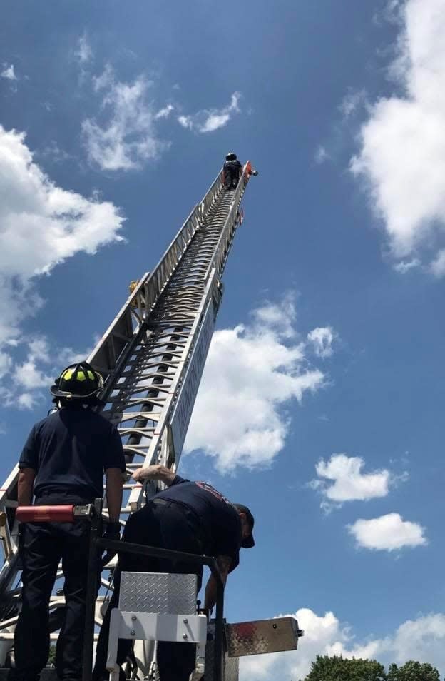 Firefighters conducting training on one of Taunton Fire Department's ladder trucks.