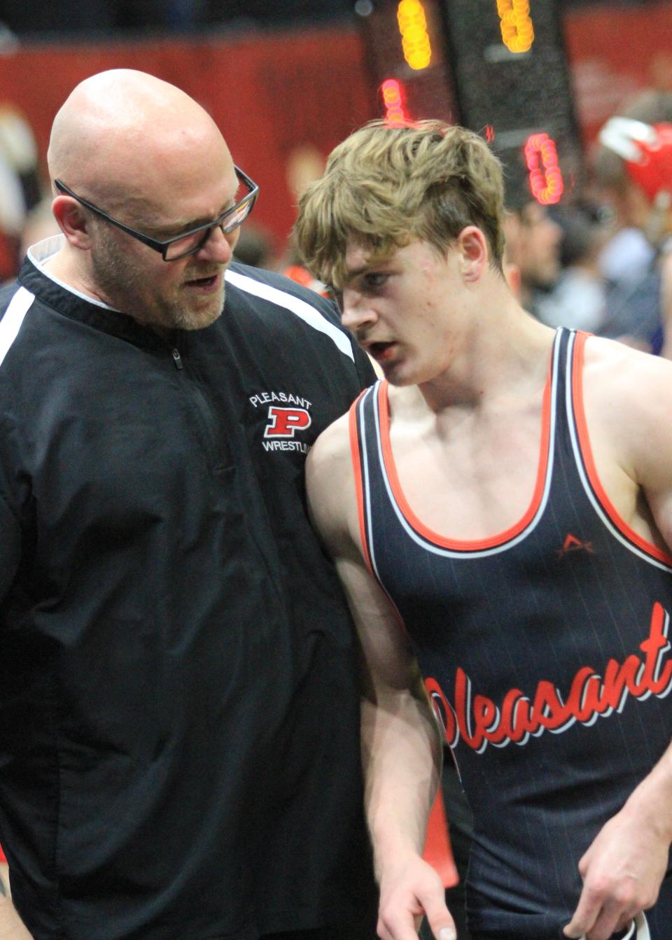 Pleasant's Daxton Chase talks to his dad and assistant wrestling coach Steve Chase following a victory in the 150-pound class during the Division III state wrestling tournament at Ohio State's Schottenstein Center. Chase went on to finish as the state runner-up.