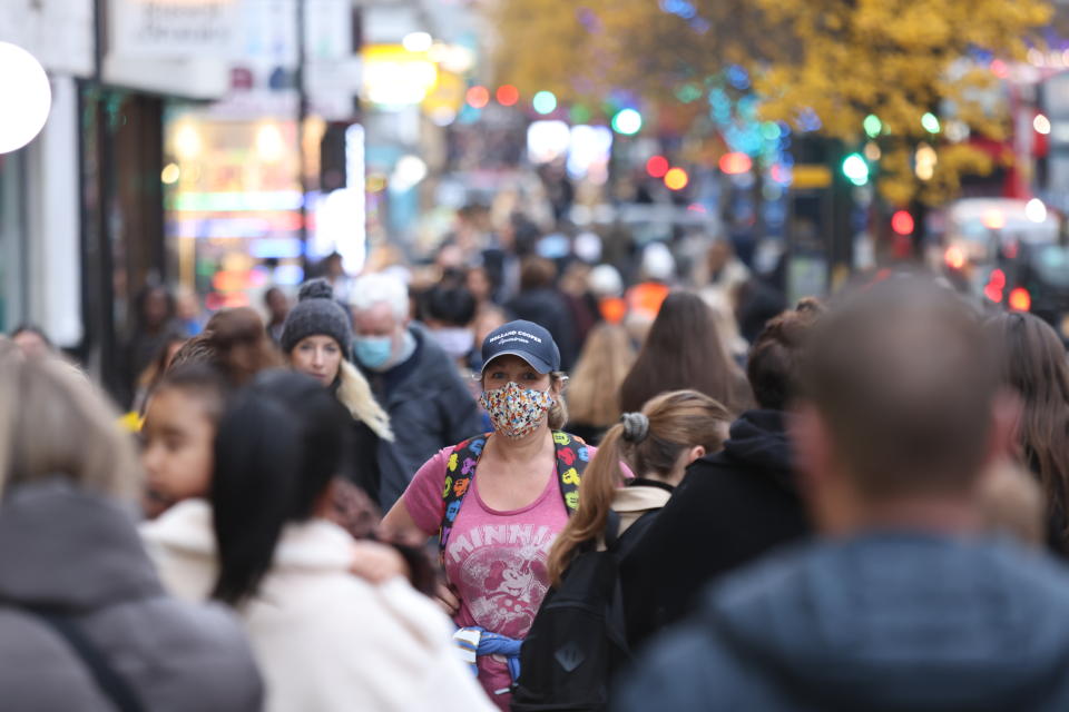 Members of the public wearing face masks as they walk along Oxford Street in London. Picture date: Wednesday December 15, 2021.