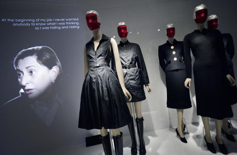 FILE - This May 7, 2012 file photo shows Miuccia Prada, left, speaking in a video about her two fashions, center, and those of Elsa Schiaparelli, right, at an exhibit at the Metropolitan Museum of Art in New York. The show "Schiaparelli and Prada, Impossible Conversations," opens May 10 and continues through Aug. 19. (AP Photo/Mark Lennihan, file)