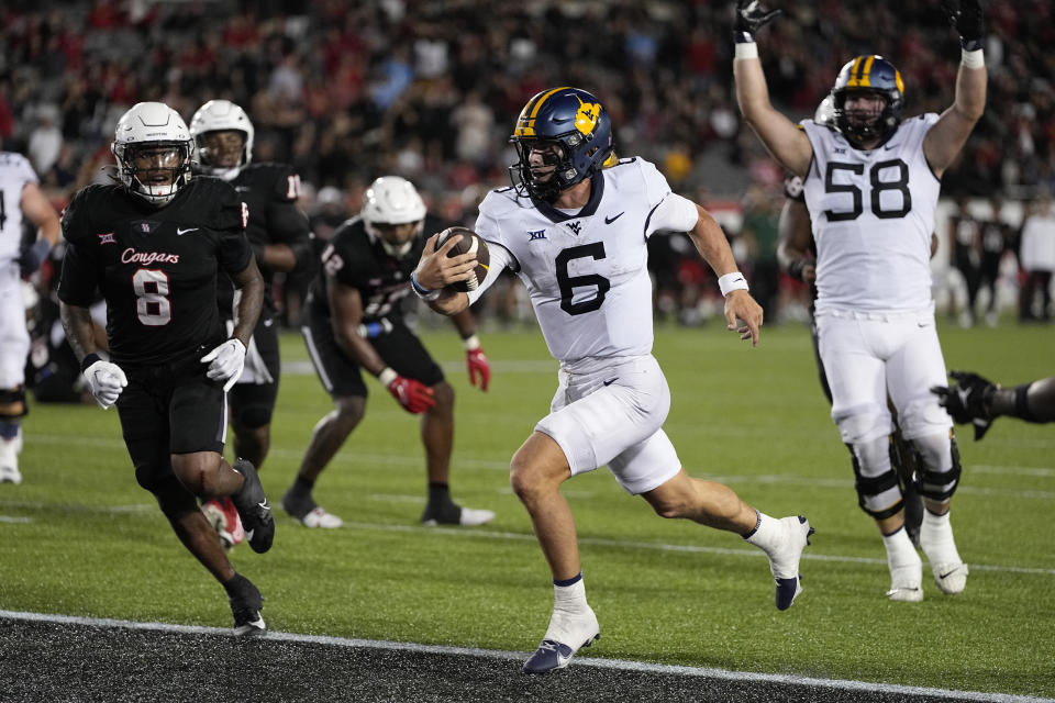 West Virginia quarterback Garrett Greene (6) rushes for a touchdown against Houston during the fourth quarter of an NCAA college football game Thursday, Oct. 12, 2023, in Houston. (AP Photo/Kevin M. Cox)
