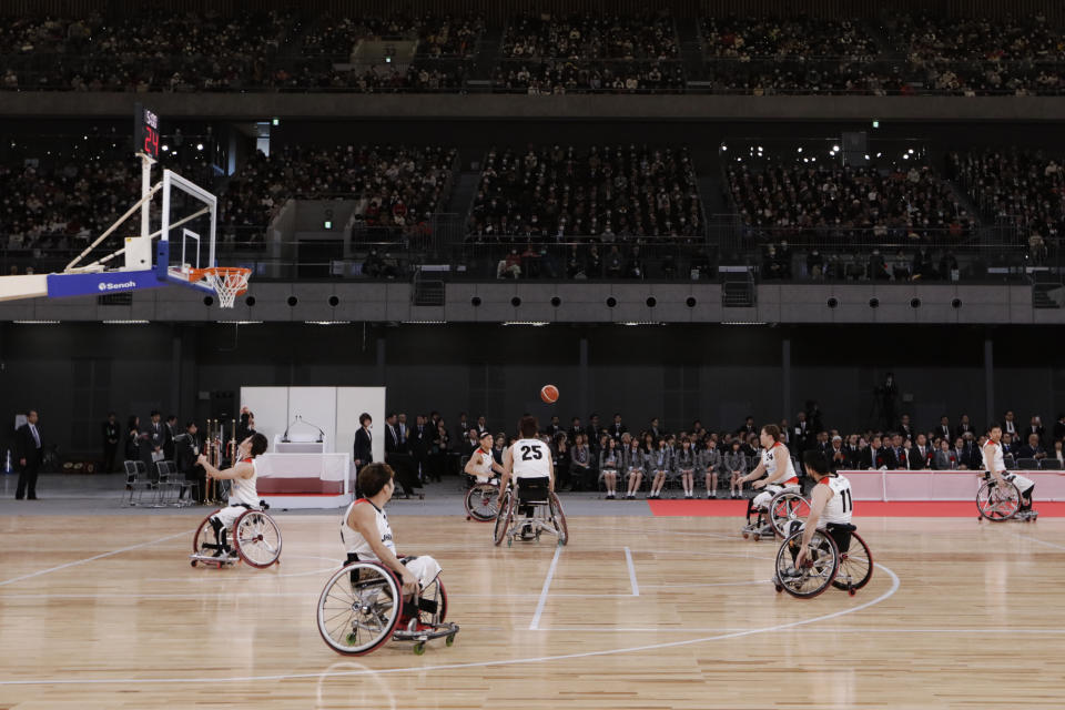 FILE - In this Feb. 2, 2020, file photo, members of Japan's national wheelchair basketball team warm up on the court during a grand opening ceremony of the Ariake Arena, a venue for volleyball at the Tokyo 2020 Olympics and wheelchair basketball during the Paralympic Games, in Tokyo. The Tokyo 2020 Paralympic schedule remains essentially unchanged for the event postponed until next year, organizers said on Monday, Aug. 3, 2020. Tokyo organizers made the same announcement several weeks ago for the postponed Olympics. The Paralympics open on Aug. 24, 2021, and close on Sept. 5. The Olympics are to open on July 23. (AP Photo/Jae C. Hong, File)