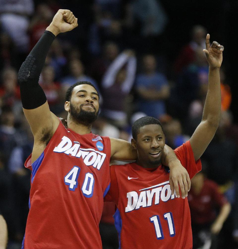 Dayton's Devon Scott (40) and Scoochie Smith (11) celebrate after the second half in a regional semifinal game against Stanford at the NCAA college basketball tournament, Thursday, March 27, 2014, in Memphis, Tenn. Dayton won 82-72. (AP Photo/John Bazemore)