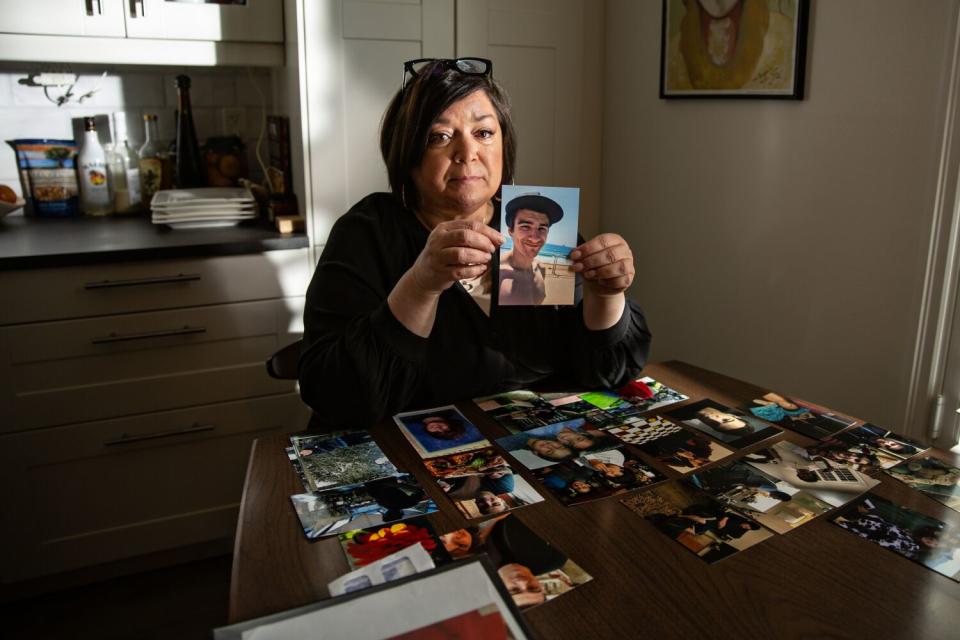 Smith holds a photo of Nicholas.