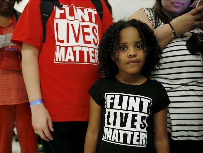 Mari Copeny, 8, of Flint, Michigan, waits in line to enter a hearing room where Michigan Governor Rick Snyder (R) and EPA Administrator Gina McCarthy will testify before a House Oversight and government Reform hearing on 