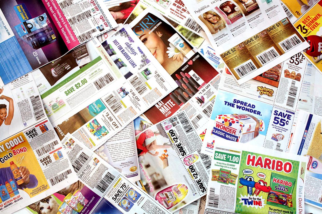 Large pile of numerous sheets of coupons from newspapers, filling the entire image