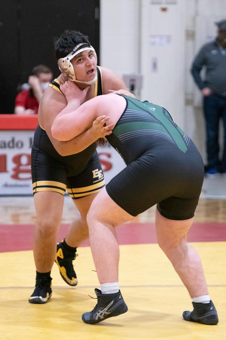 East High School's Daniel Duarte, left, checks the clock during the 220-pound matchup with Fossil Ridge's Roman Ragazzo at the Coronado quad on Saturday February 13, 2021.