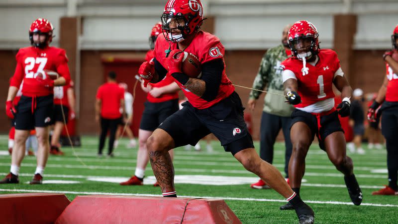 Utah players run through drills during spring camp at the University of Utah in Salt Lake City. Coaches use the practices sessions to evaluate talent and build depth.