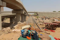 A child from a homeless family sits on a bed, on the track of the disused Karachi Circular Railway line in Karachi, Pakistan, May 23, 2017. REUTERS/Caren Firouz/Files