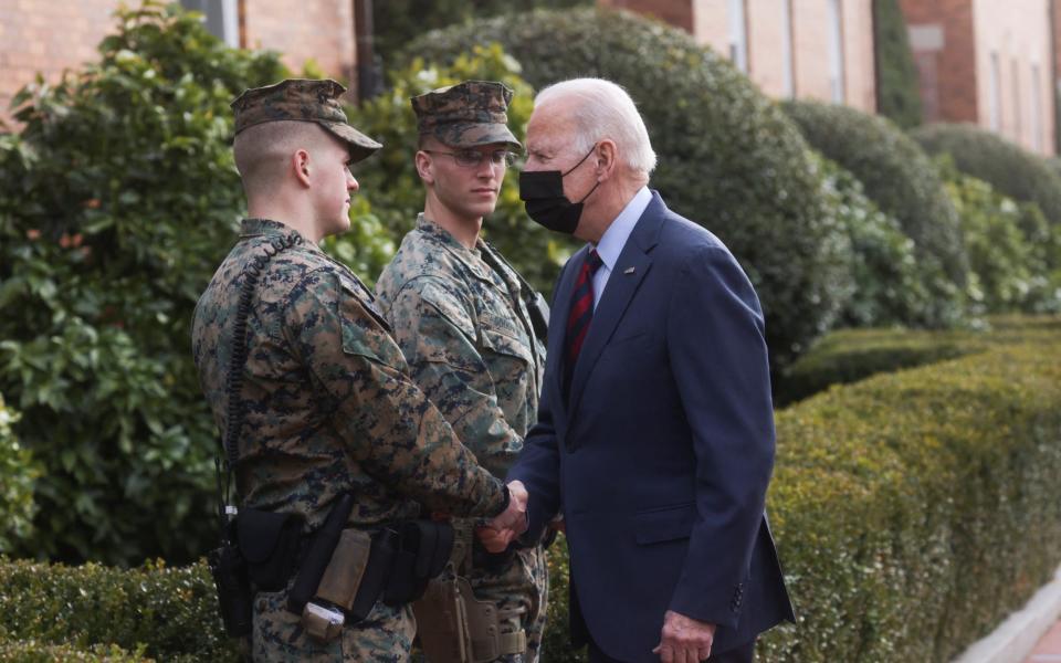 Joe Biden greets a pair of US Marines in Washington. The US is considering sending 8,500 troops to Eastern Europe