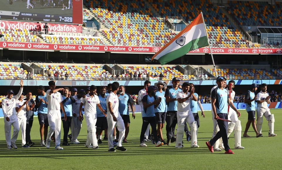 Indian players celebrate after defeating Australia by three wickets on the final day of the fourth cricket test at the Gabba, Brisbane, Australia, Tuesday, Jan. 19, 2021.India won the four test series 2-1. (AP Photo/Tertius Pickard)