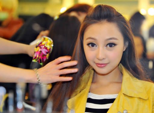 Chinese native Qi Ji has her make-up done during a new talent show "Asian Idol Group Competition" in Taipei, in May. Growing numbers of young Chinese performers are eschewing the entertainment scene at home and instead coming to Taiwan in the hope of getting a big break