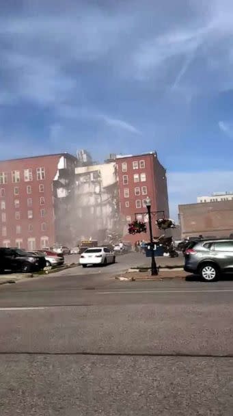 PHOTO: Dust can be seen in the air moments after a building collapsed in Davenport, Iowa, on May 28, 2023. (Caleb Tvedt)