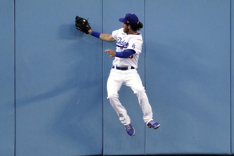 Los Angeles Dodgers center fielder Cody Bellinger makes a catch at the wall on a ball hit by Texas Rangers' Joey Gallo during the second inning of a baseball game Friday, June 11, 2021, in Los Angeles. (AP Photo/Mark J. Terrill)