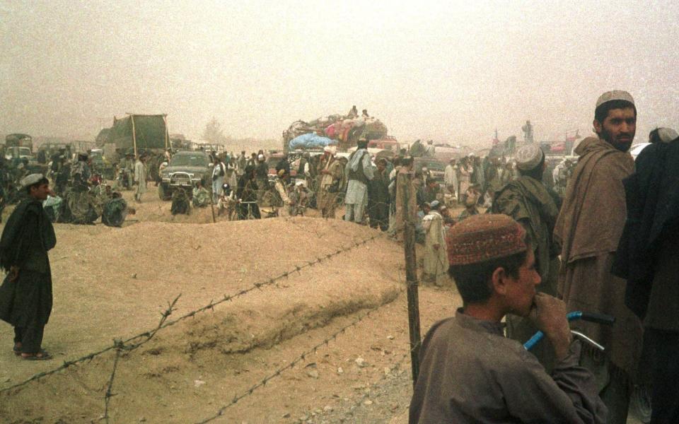 Refugees cross the border into Pakistan to flee the US invasion in 2001 - REUTERS