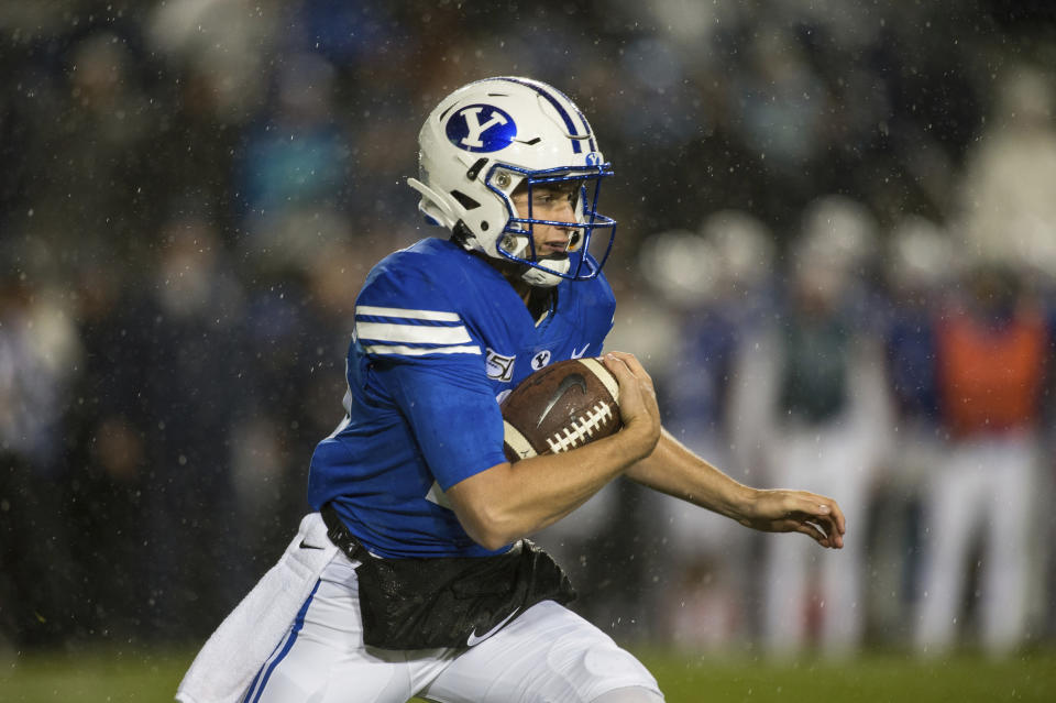 FILE - In this Saturday, Oct. 19, 2019, file photo, BYU quarterback Baylor Romney runs during the first half of the team's NCAA college football game against Boise State in Provo, Utah. It's a three-QB race to run the offense in place of Zach Wilson, who was the No. 2 overall pick by the New York Jets in the NFL draft. (AP Photo/Tyler Tate, File)