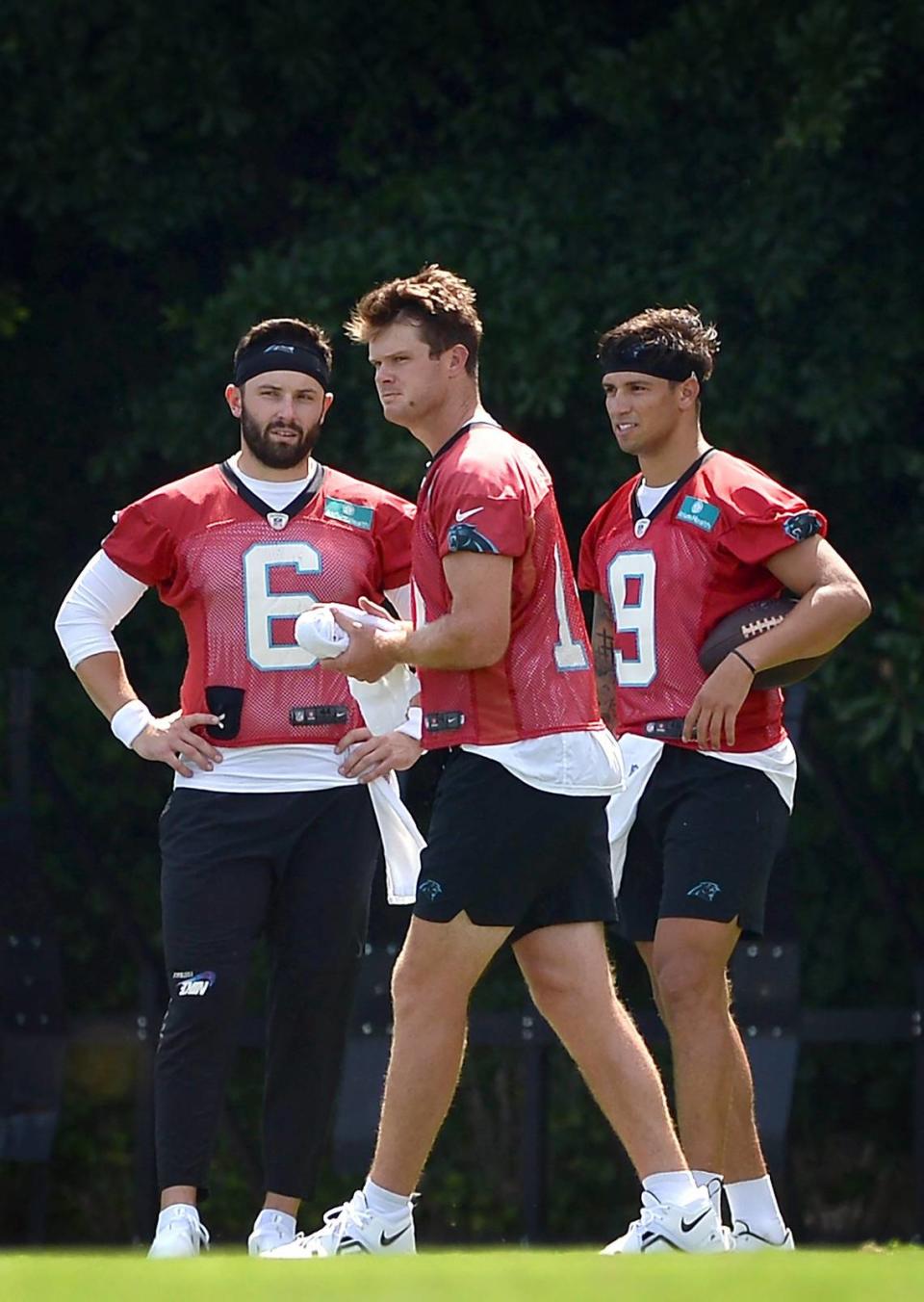 Carolina Panthers quarterbacks Baker Mayfield, left, Sam Darnold, center and Matt Corral, right, wait along a sideline to resume drills in July 2022. Of the three, only Corral (9) remains, and he’s given up that number to Bryce Young.
