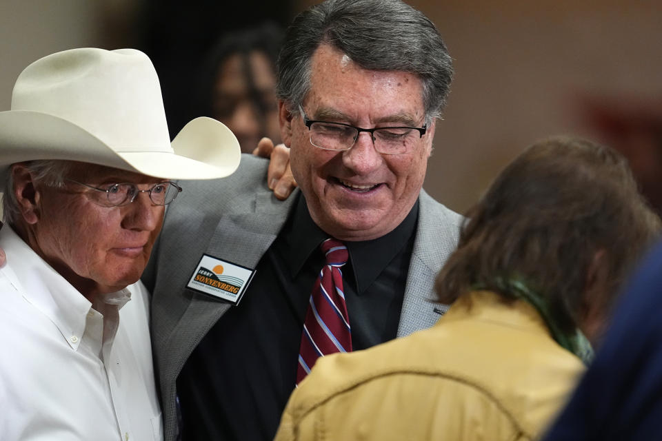 Former Colorado lawmaker Jerry Sonnenberg, center, greets well-wishers during a meet-and-greet before the first Republican primary debate for the 4th Congressional district seat being vacated by Ken Buck Thursday, Jan. 25, 2024, in Fort Lupton, Colo. (AP Photo/David Zalubowski)