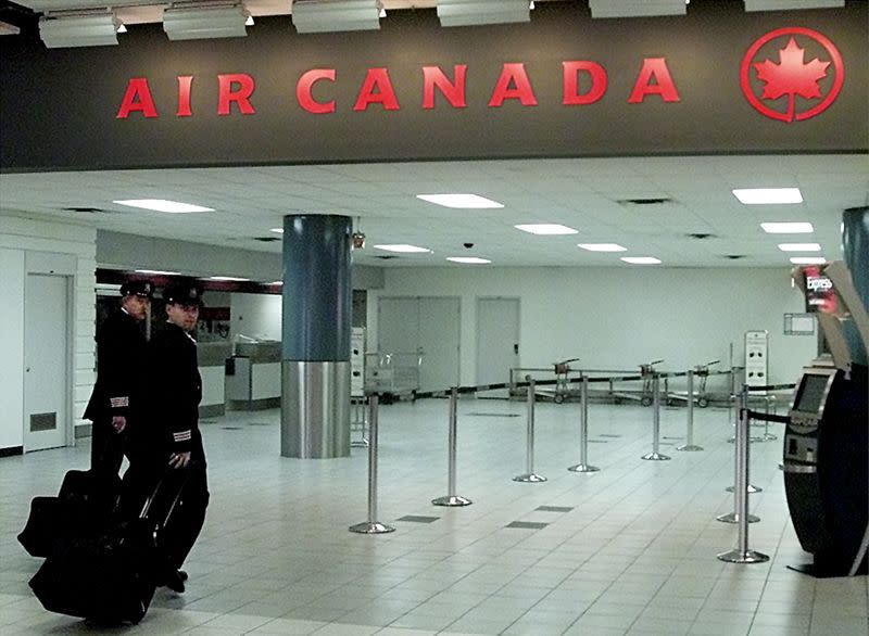 FILE PHOTO: Air Canada pilots walk towards their gate at Toronto's Pearson International Airport