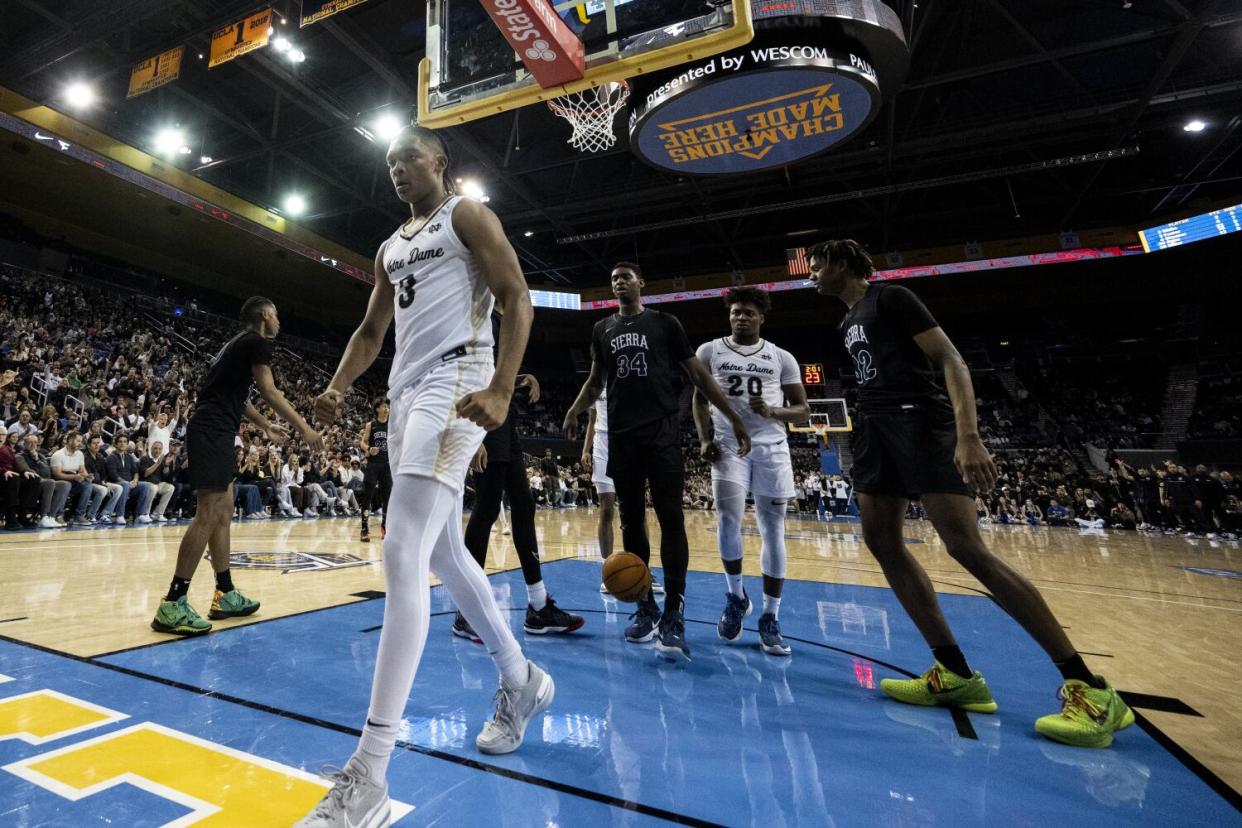 Notre Dame's Caleb Foster (3) reacts after drawing a foul and scoring a basket against Sierra Canyon at Pauley Pavilion.