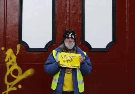 A man holds a sign during an anti-fracking protest in Preston, northern England January 28, 2015. REUTERS/Darren Staples