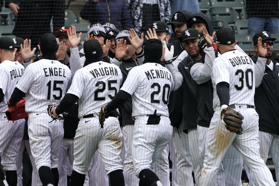 The Chicago White Sox celebrate the team's 7-3 win over the Kansas City Royals after a baseball game Wednesday, April 27, 2022, in Chicago. (AP Photo/Charles Rex Arbogast)