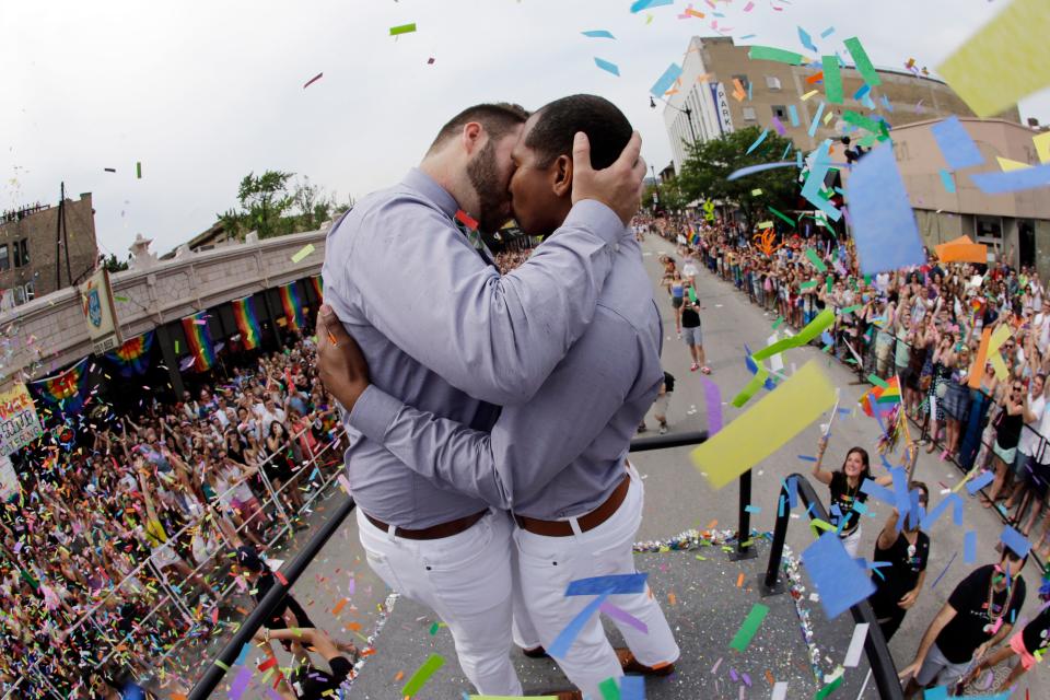 Scotty Brown, 32, left, of Chicago, kisses Roger Knight, 31, of Chicago, as they get married during the Chicago Pride Parade on Broadway Street on Sunday, June 28, 2015, in Chicago.