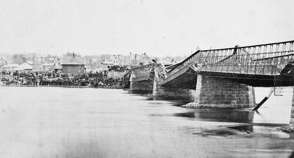 This photo provided by Lee County Historical and Genealogical Society shows the Truesdell Bridge in Dixon, Ill., following its collapse in 1873. It's been 150 years since the bridge collapsed, remaining the worst road-bridge disaster in American history. On May 4, 1873, a crowd of more than 200 gathered on the bridge to watch a baptism when it toppled over, trapping dozens of victims just inches below the river's surface. The disaster claimed 46 lives and injured dozens of others. (Charles Keyes/Lee County Historical and Genealogical Society via AP)