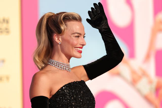 <p>Christopher Polk/WWD</p> Margot Robbie poses at the Barbie premiere.