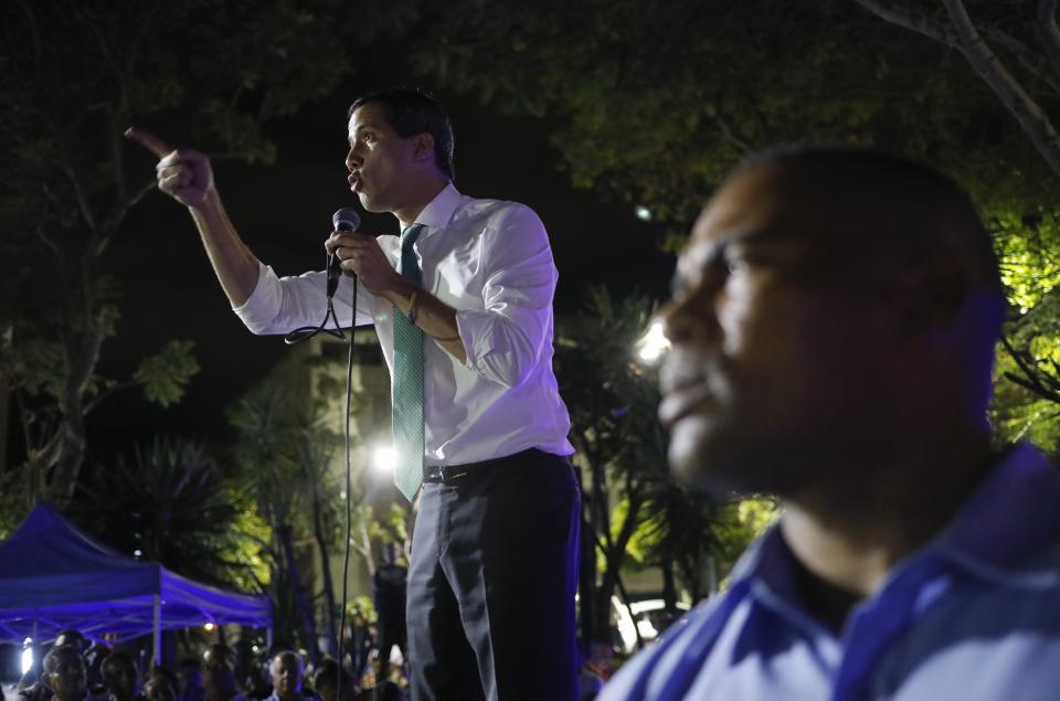 Venezuelan opposition leader and self-proclaimed interim president Juan Guaido speaks during a citizen's meeting in in Caracas, Venezuela, Wednesday, Nov. 13, 2019. Guaido is calling people across the crisis-torn nation to flood the streets for protests nearly a year since launching an urgent campaign to push President Nicolás Maduro from power. (AP Photo/Ariana Cubillos)